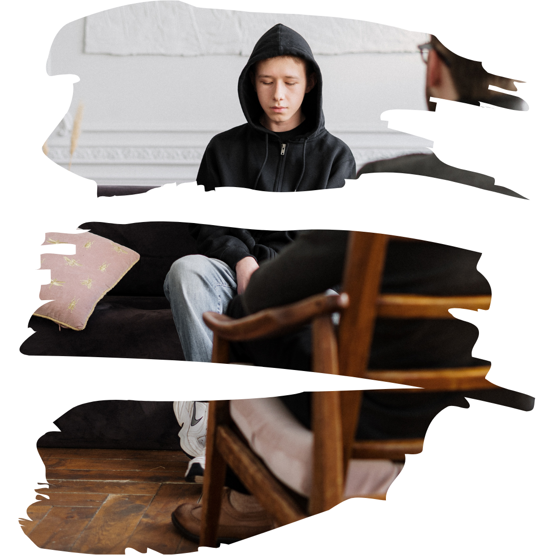 A person in a black hoodie sits on a therapy couch looking down.